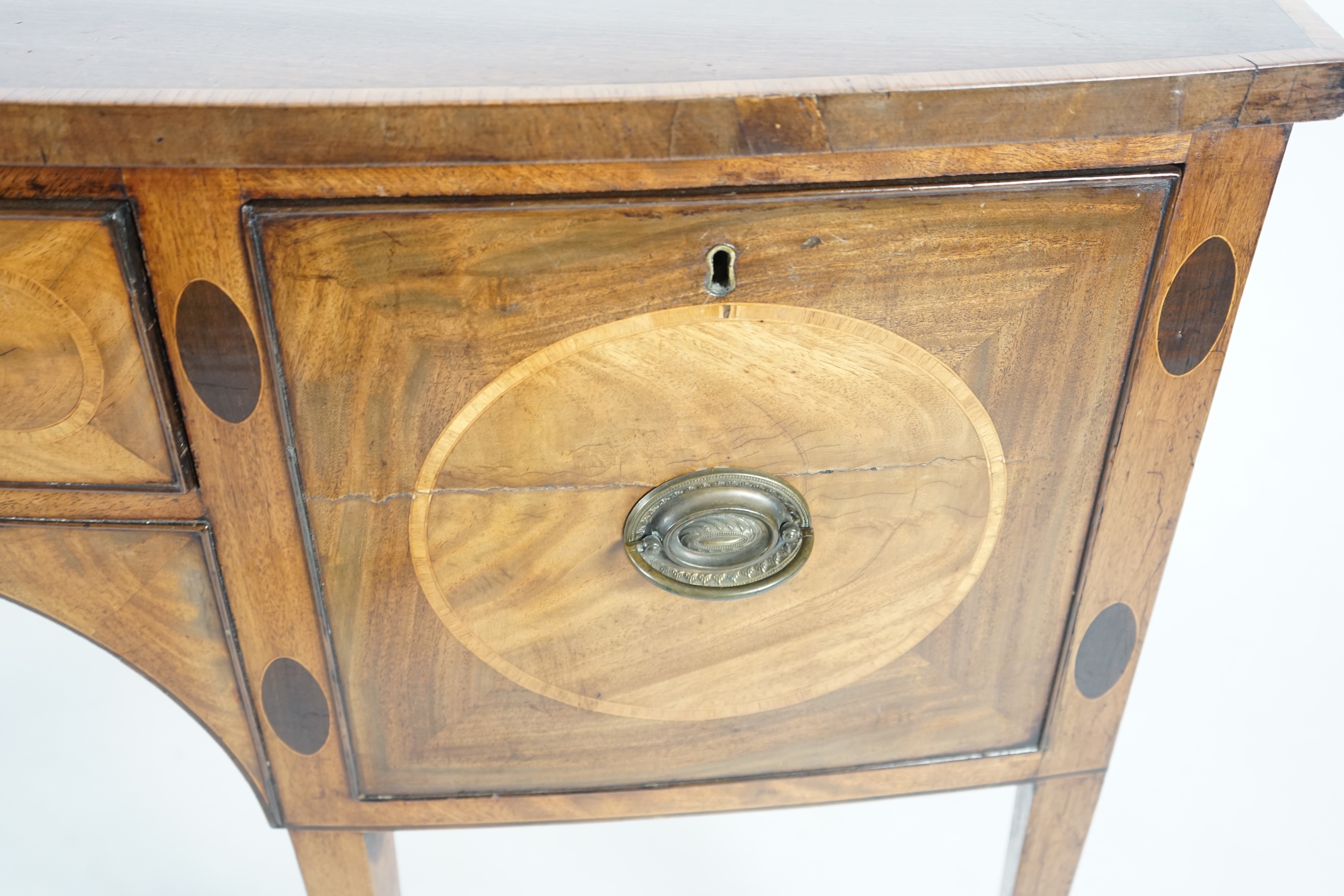 A George III rosewood banded mahogany bowfront sideboard